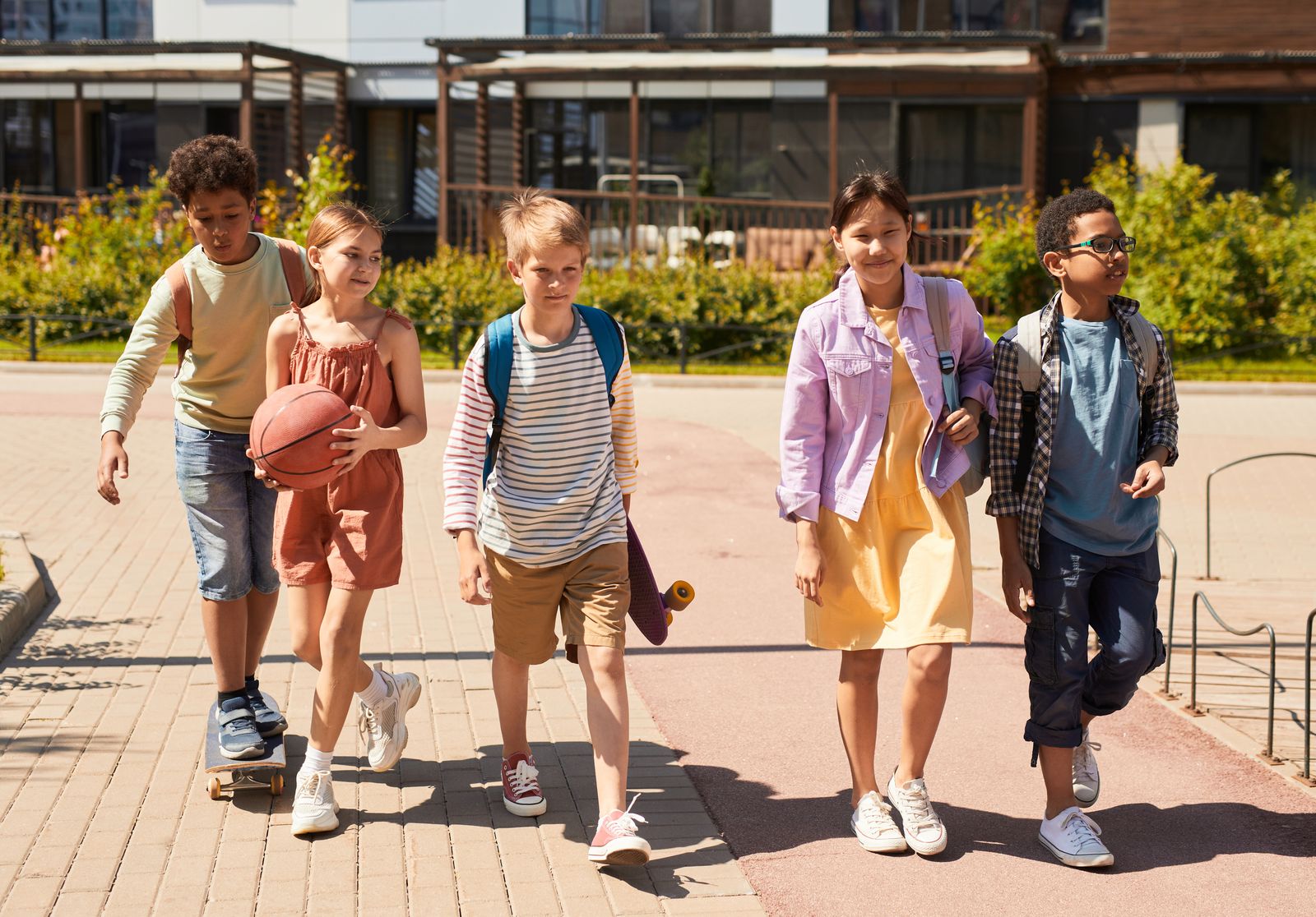 A diverse group of school-age students walking together outdoors
